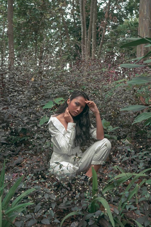 Sitting Woman Surrounded by Trees and Plants