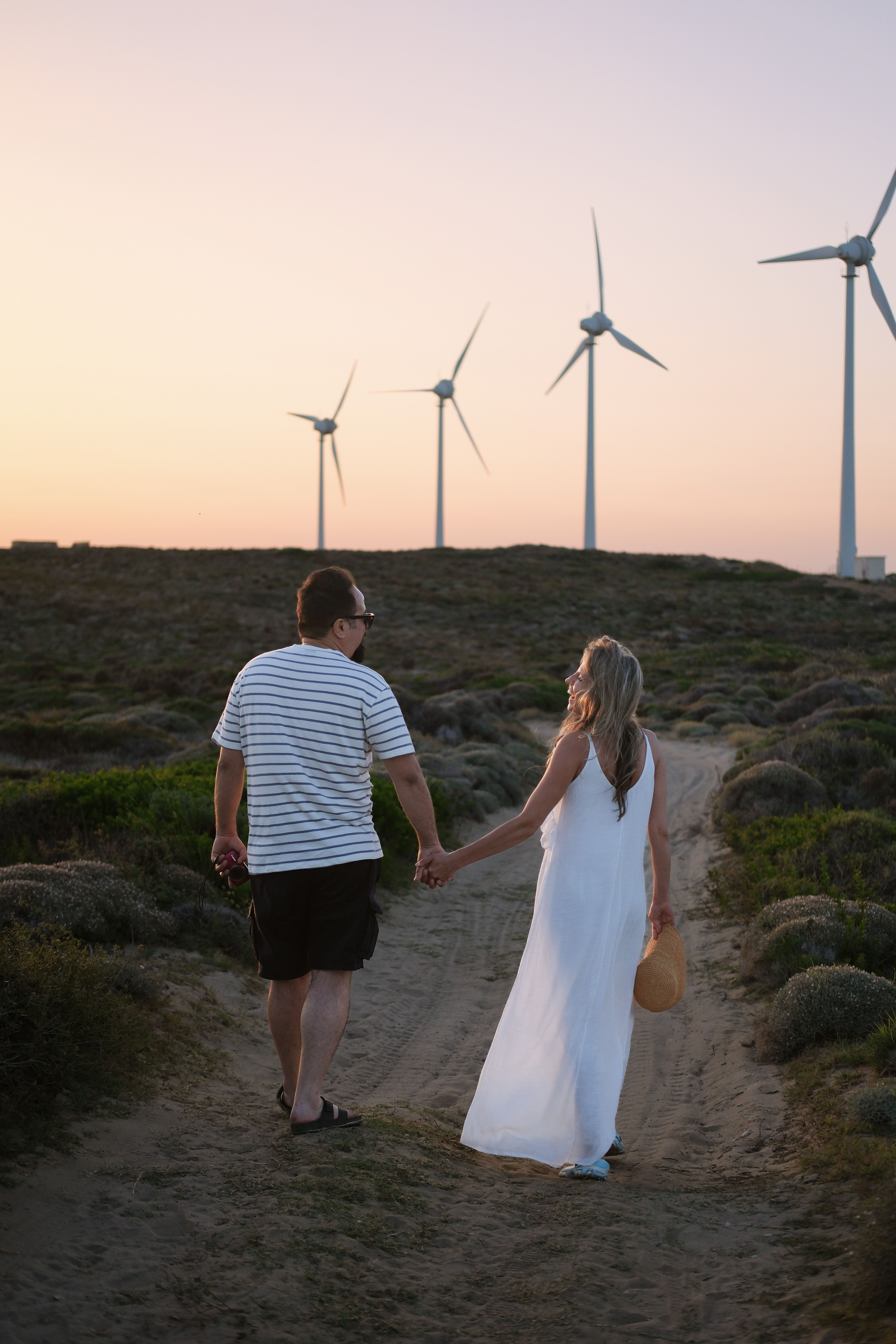 Back View of a Couple Walking on a Footpath · Free Stock Photo