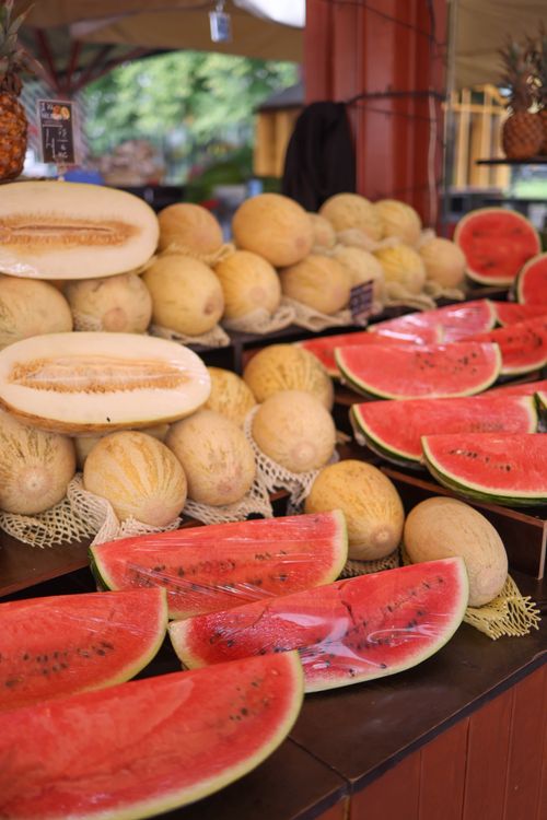 Free Vibrant display of watermelons and melons at an outdoor market stall, showcasing summer fruits. Stock Photo