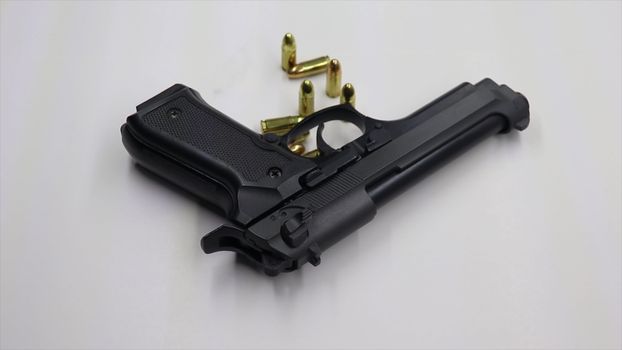 Pistol and Bullets on a White Background