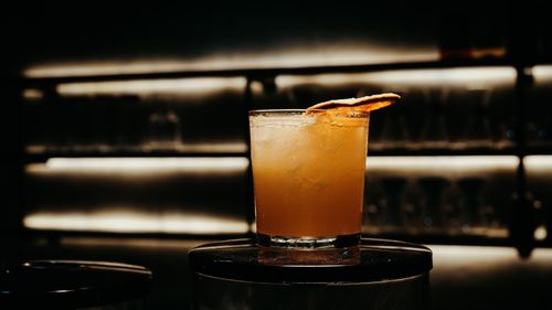 Free A refreshing cocktail with citrus garnish served in a chilled glass on a bar counter. Stock Photo