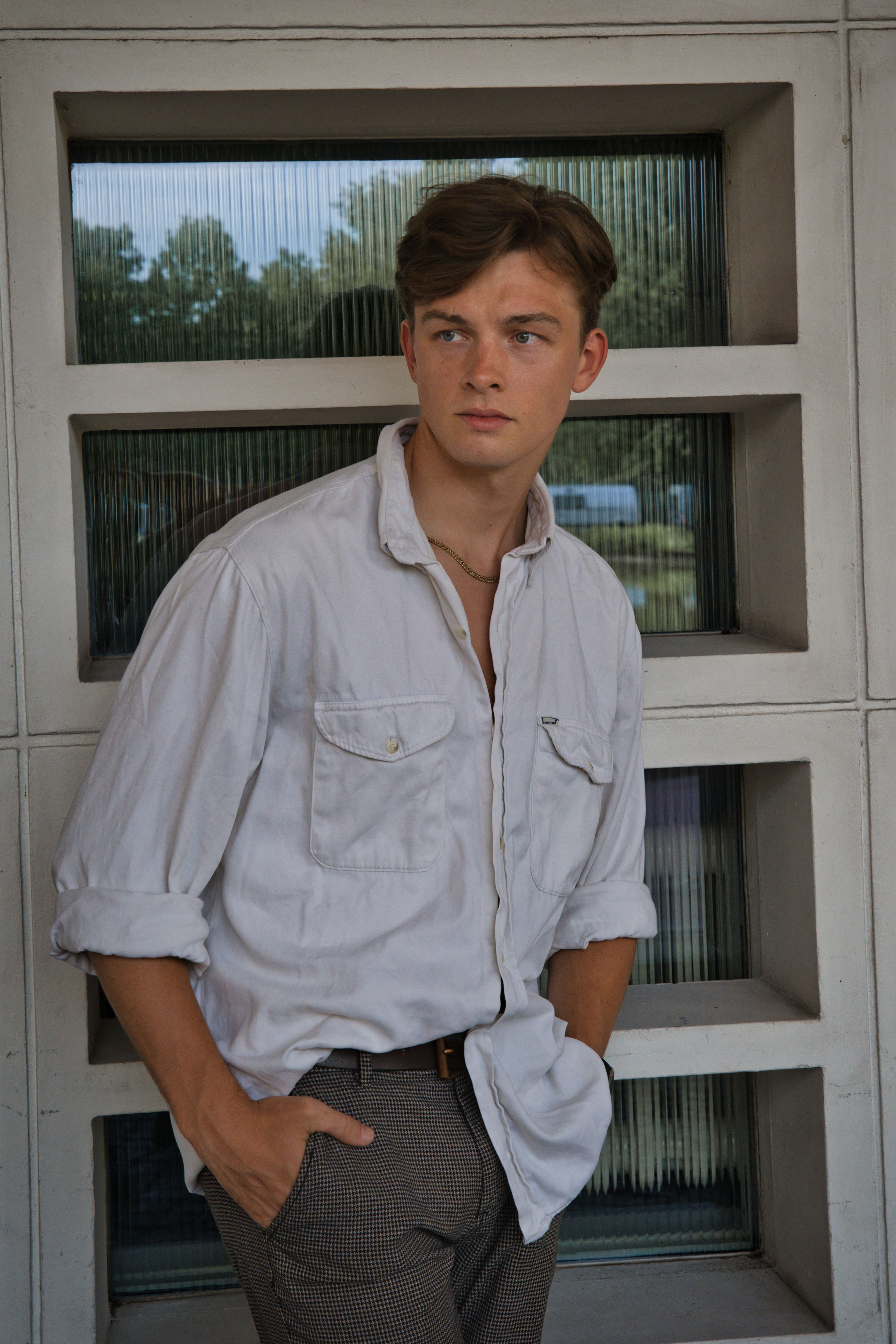 Young man in casual fashion posing confidently outdoors in Berlin. Stylish and modern.