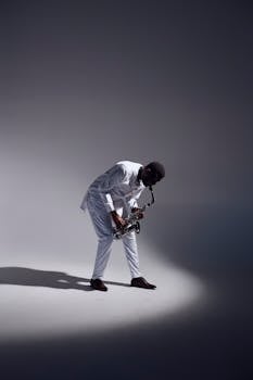 A well-dressed saxophonist performs passionately in a studio. Perfect for music and lifestyle themes.