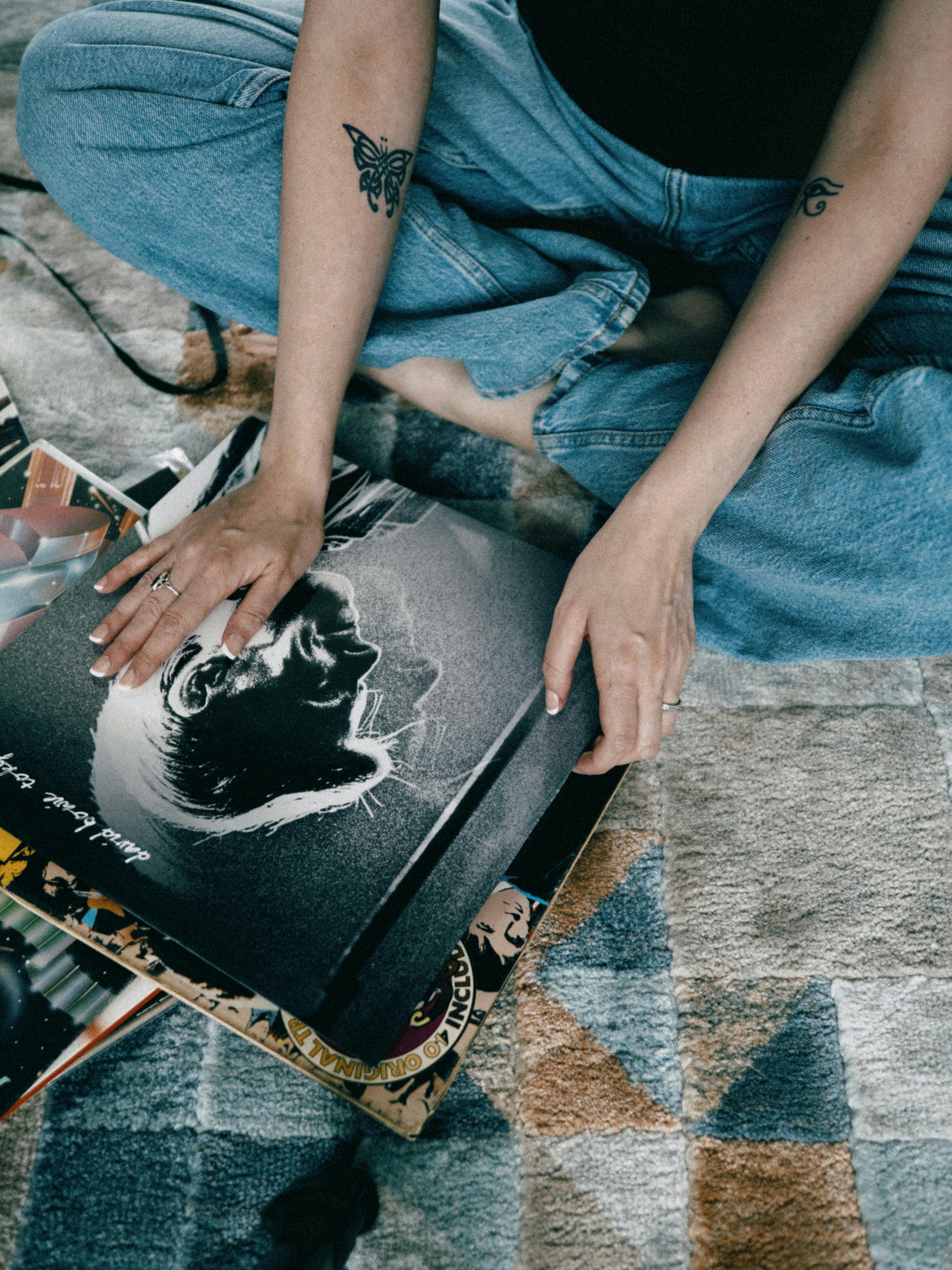 woman sitting with vinyl disks