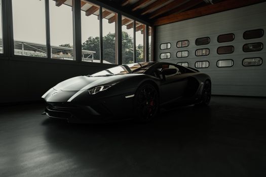 Elegant sports car showcased in a stylish indoor garage setting.