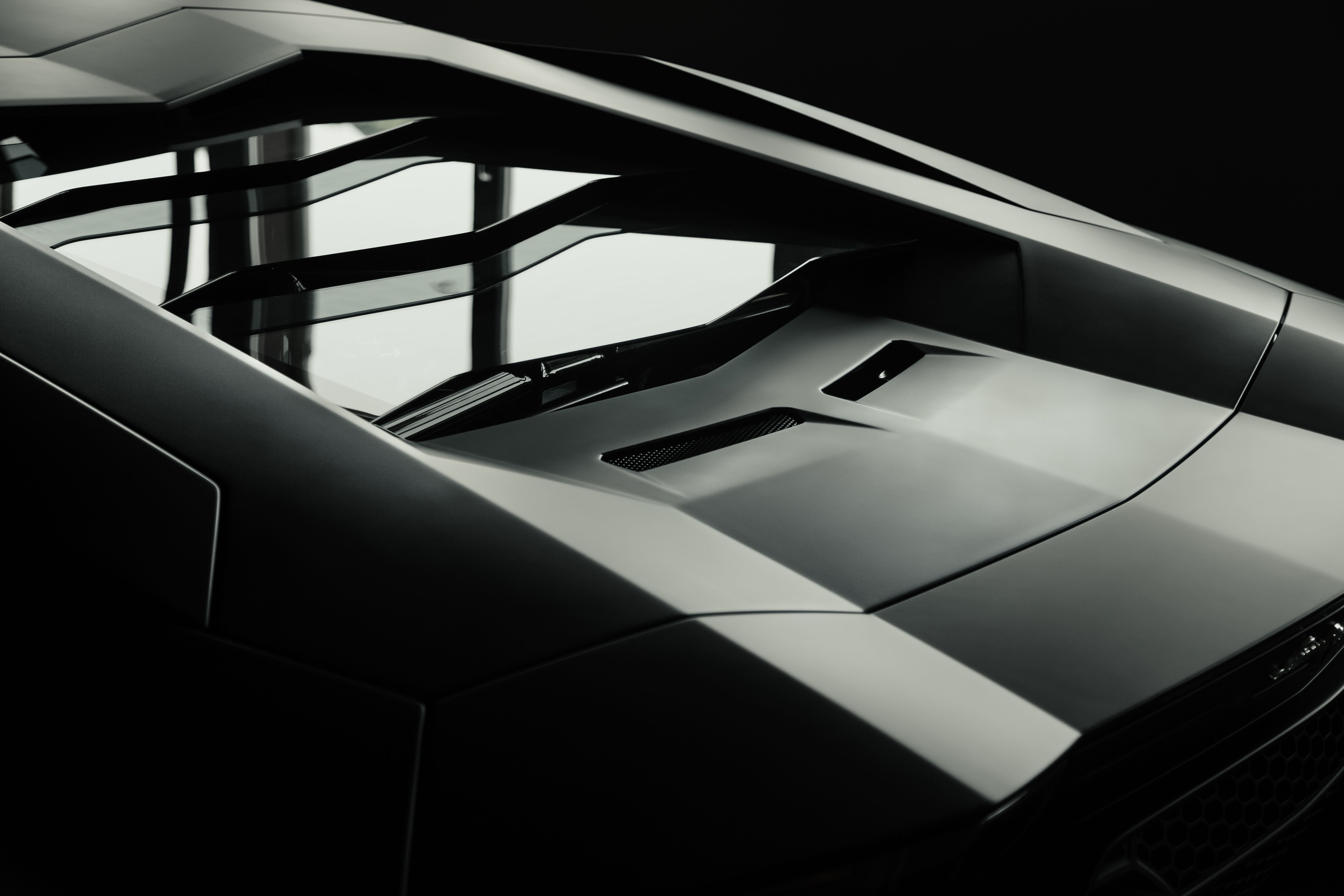 A close-up of a sleek luxury sports car showing its aerodynamic curves and modern design.