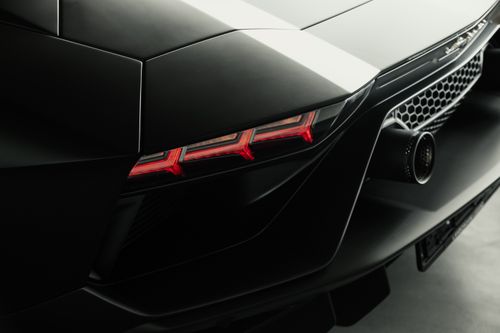 Free Sleek design and rear detail of an elegant sports car with a focus on taillights and aerodynamic structure. Stock Photo
