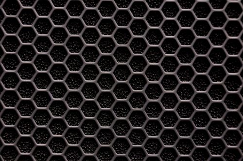 Free Close-up of a metallic hexagonal grid pattern, resembling a honeycomb structure. Stock Photo