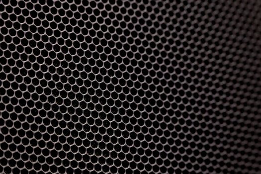 A detailed image showcasing a metallic honeycomb structure with hexagonal pattern, offering a modern texture.