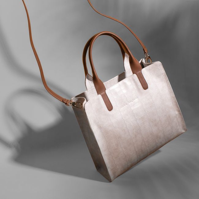 Luxury crocodile leather handbag in a studio shoot showcasing elegance and style. - Current Seasonal Trends in Handbag Fashion