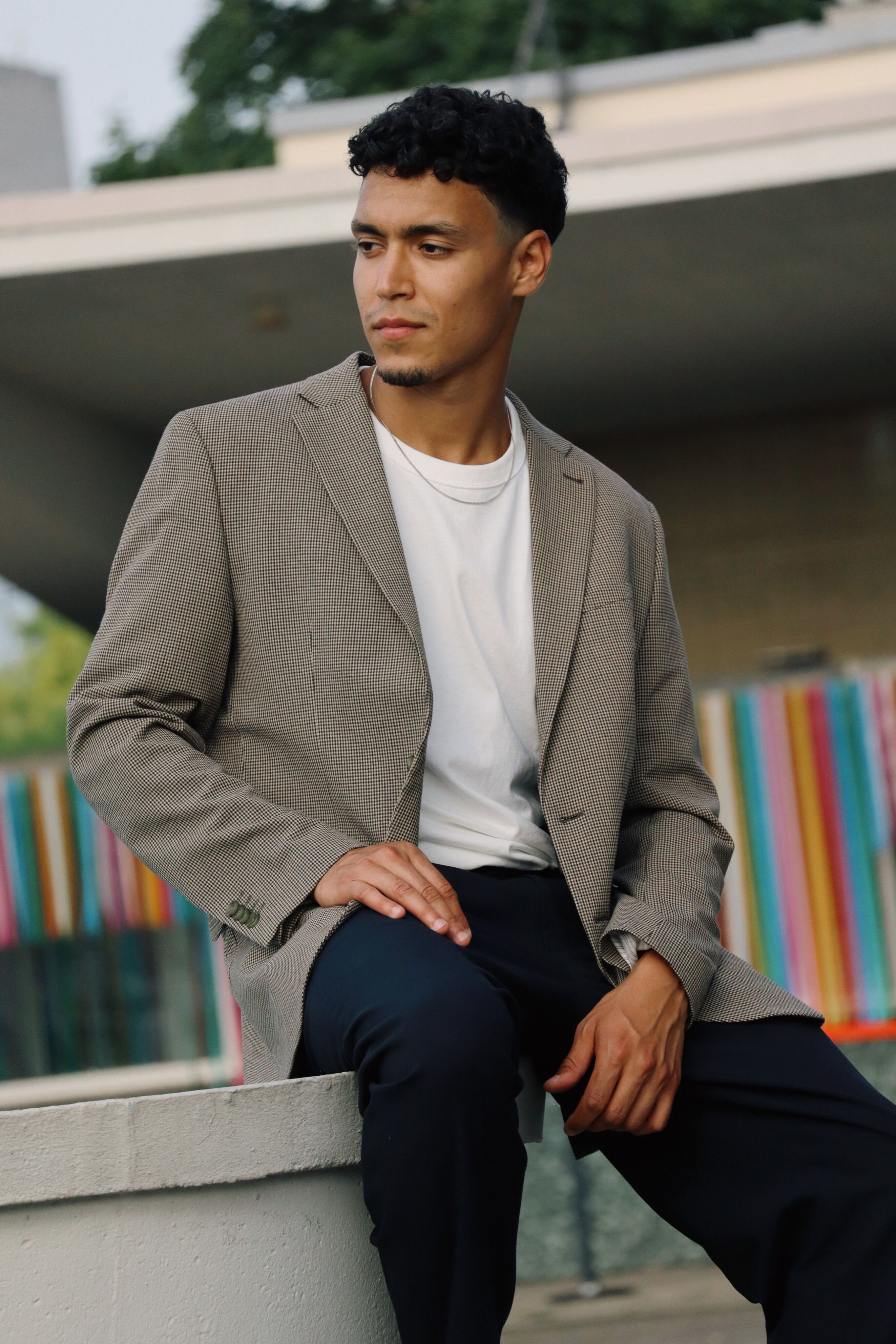 Fashionable man in a smart casual outfit poses outdoors in Berlin, Germany.