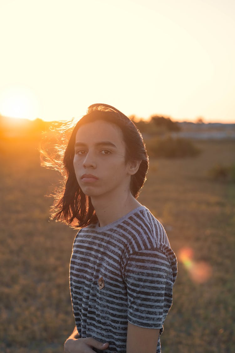 Calm Teenager Resting In Countryside During Sunset