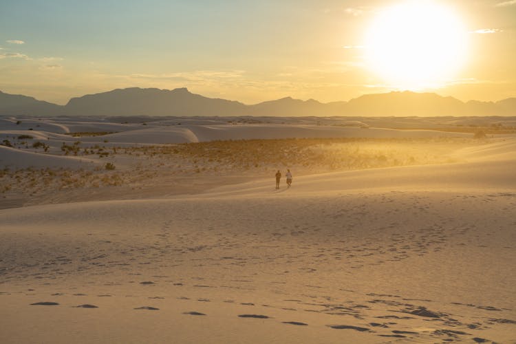 People On Desert At Sunset