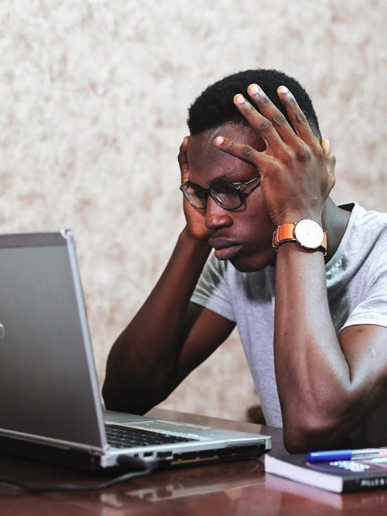 Man Looking Frustrated While Staring at his Laptop