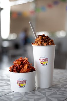 Close-up of Mexican snacks in disposable cups at Estación Culiichi.