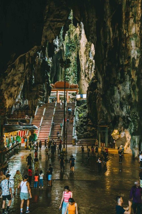 Free Tourists exploring the iconic Batu Caves in Kuala Lumpur, Malaysia, a popular cultural and religious site. Stock Photo