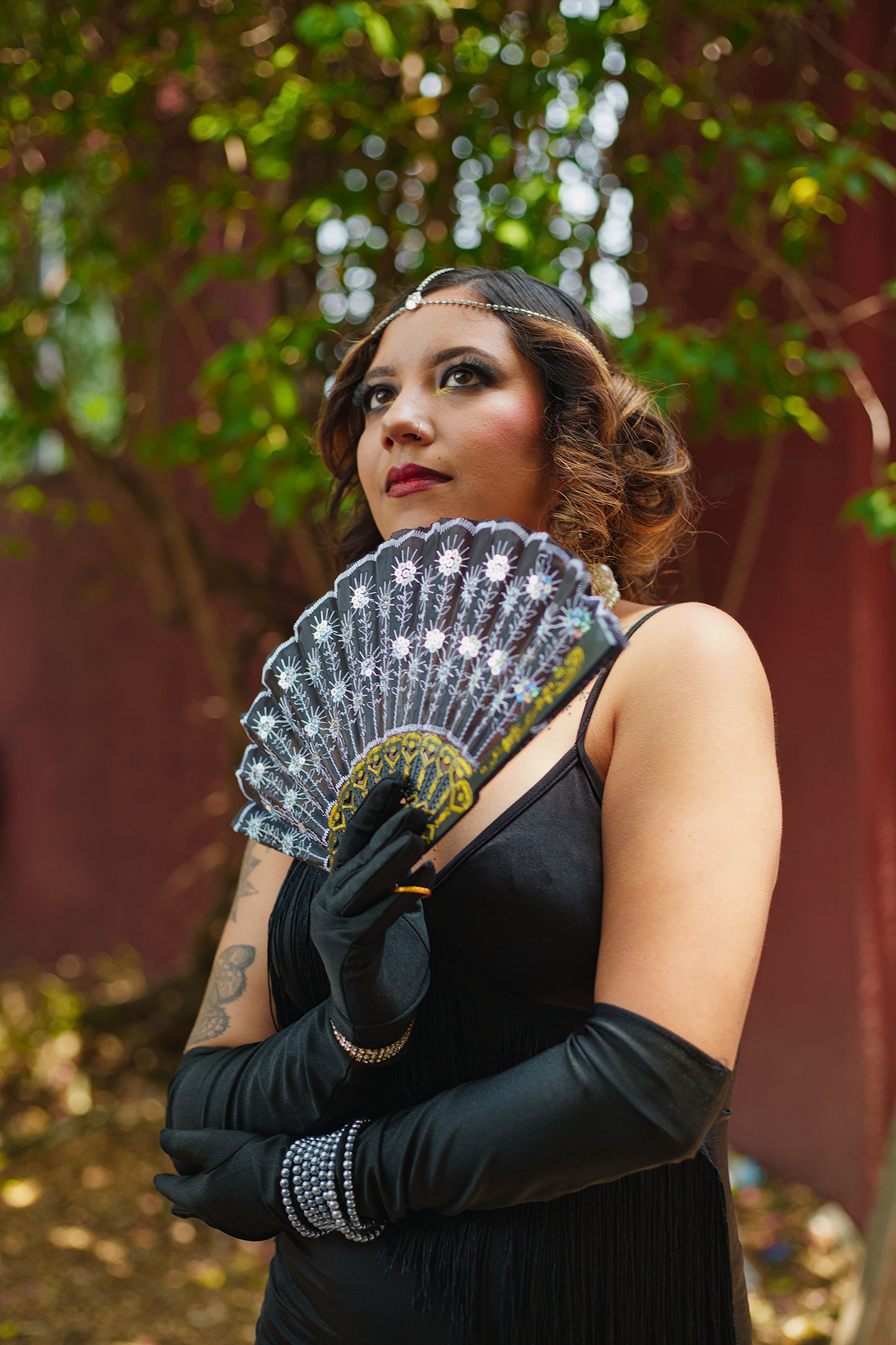 Elegant Woman in a Black Dress and Gloves Holding a Hand Fan · Free Stock  Photo