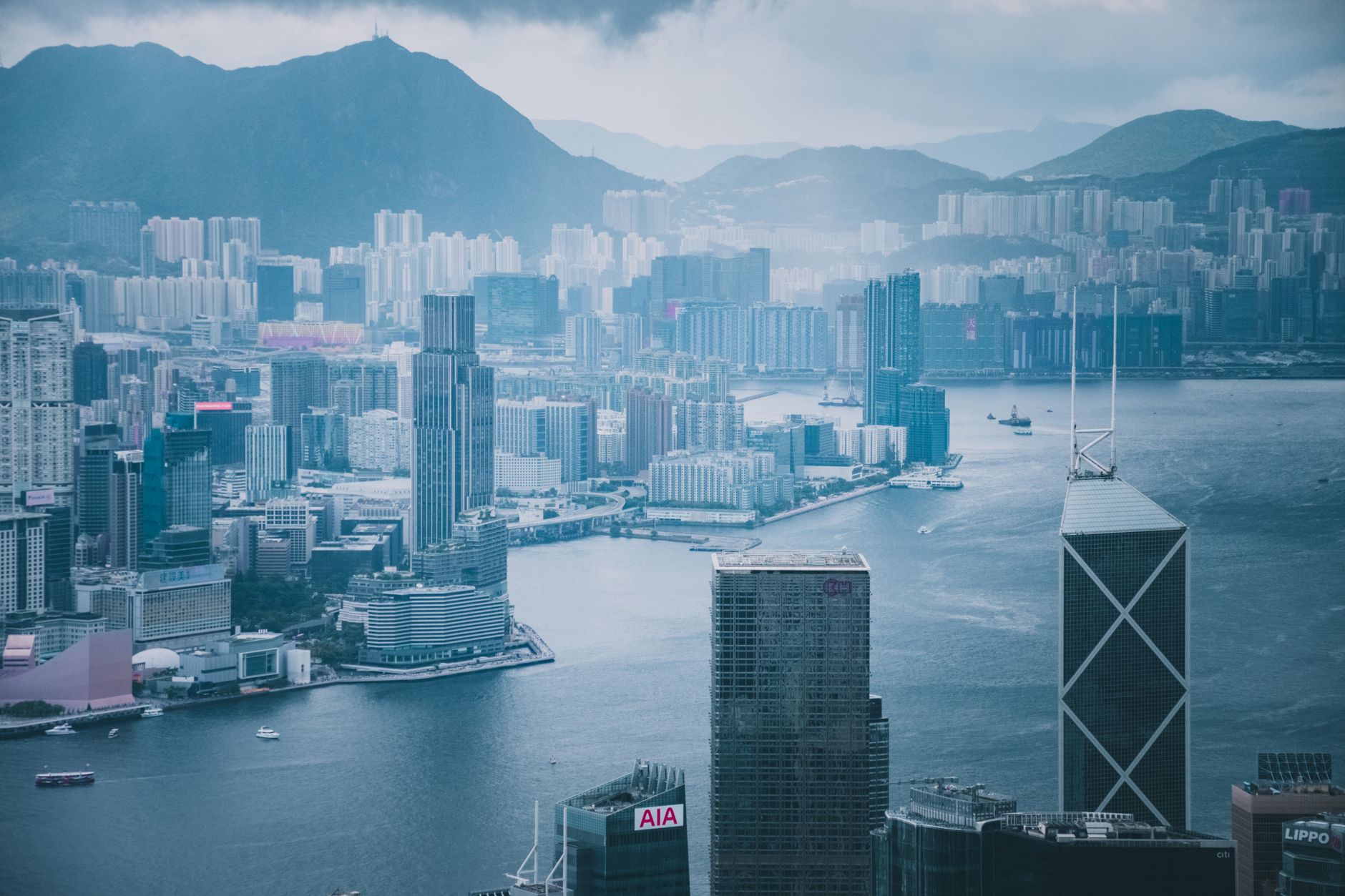 Stunning aerial cityscape of Hong Kong with skyscrapers and Victoria Harbour.