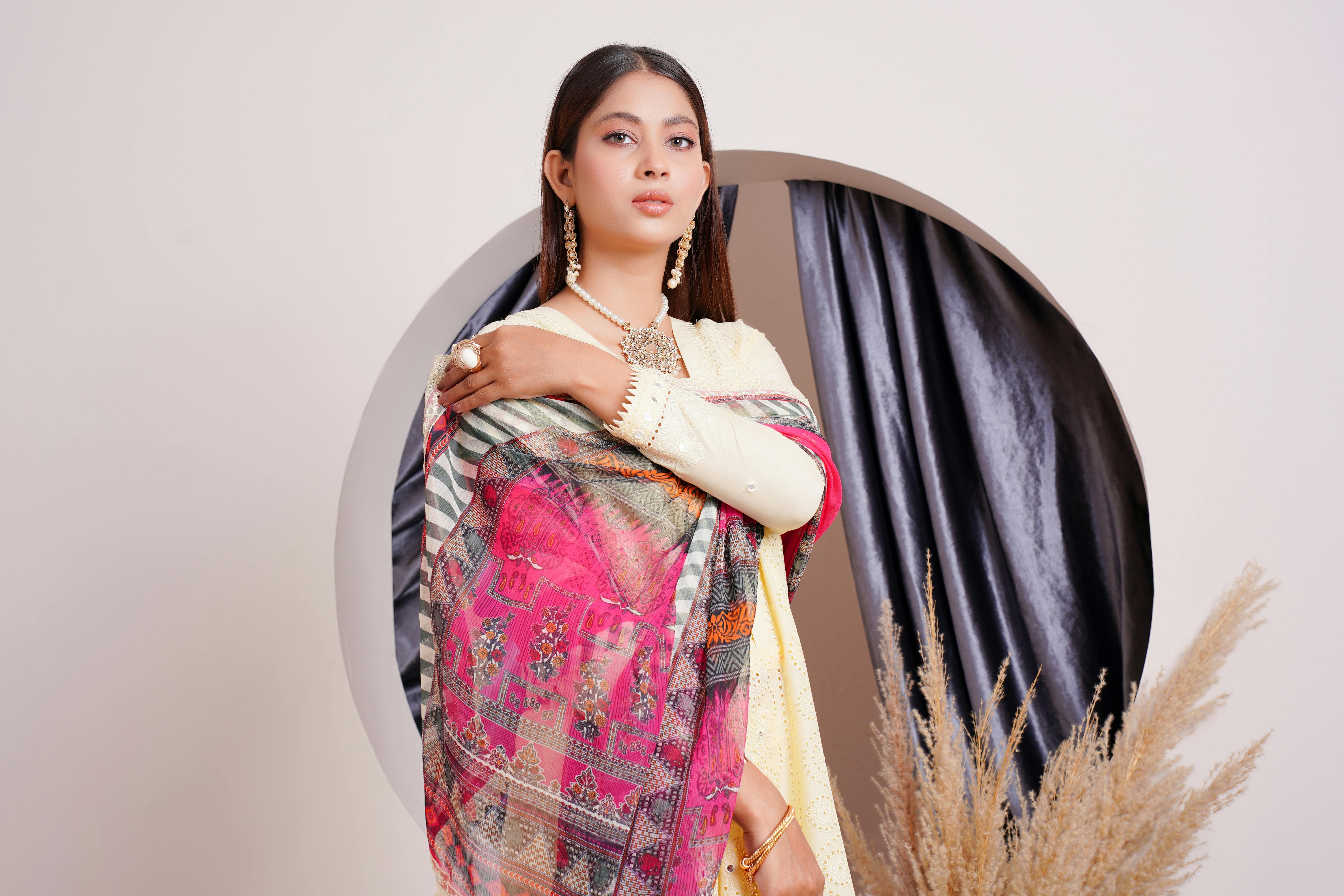 portrait of a female model wearing a yellow dress and a shawl