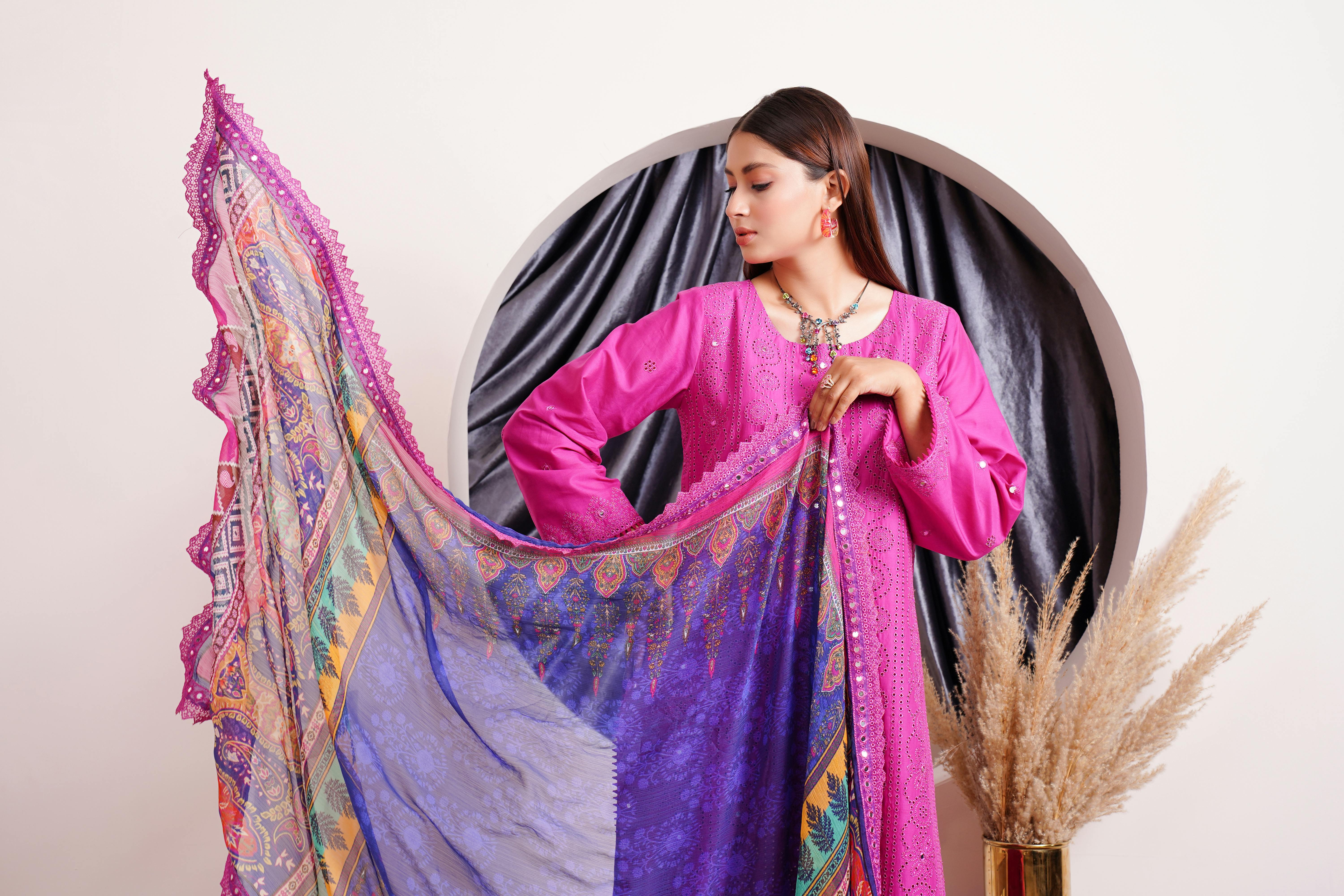 portrait of a female model wearing a pink dress holding a shawl