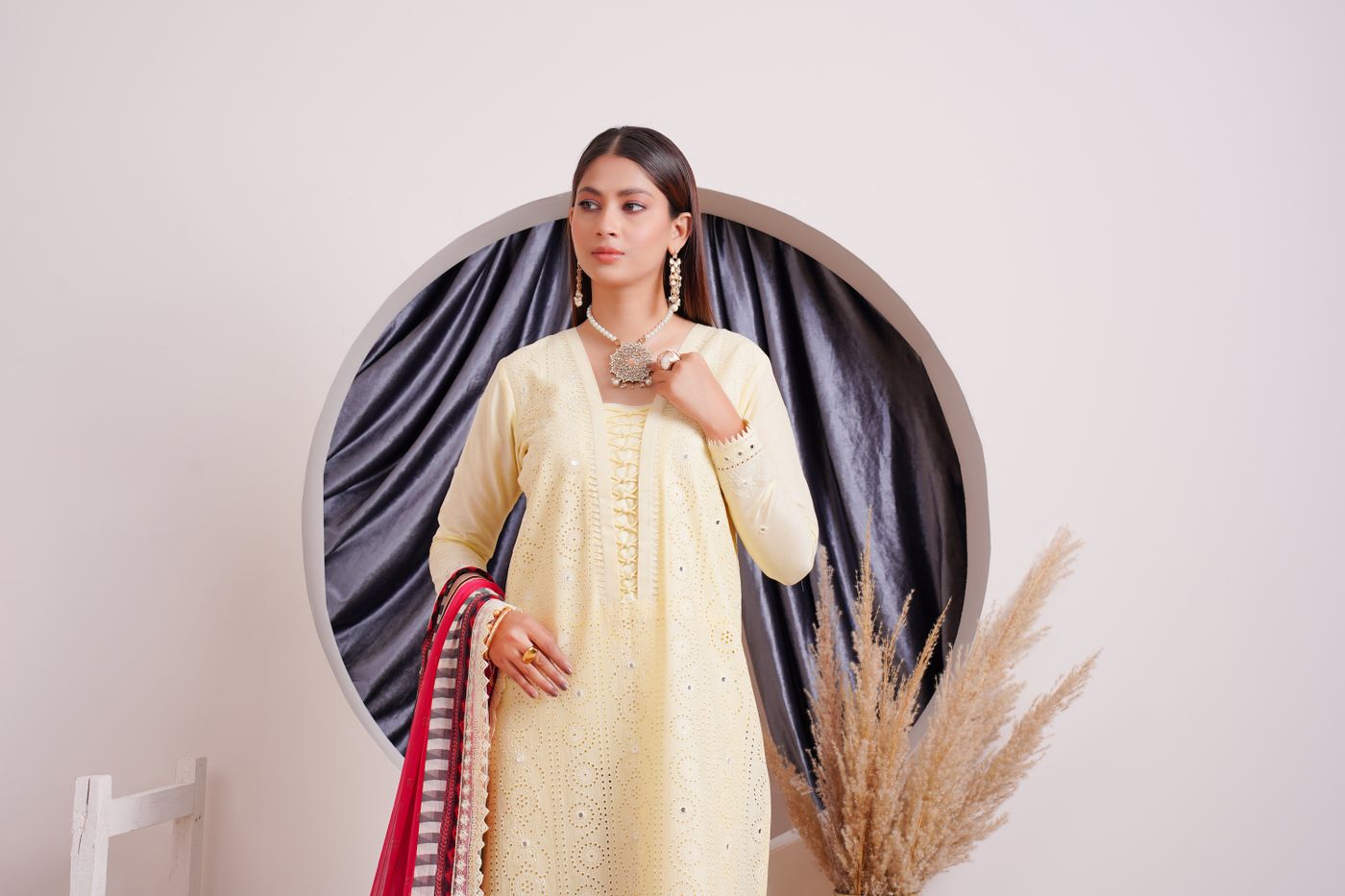 Elegant South Asian fashion model wearing a necklace with traditional attire