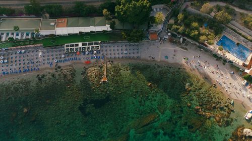 Free Stunning aerial shot of a beach resort with clear waters and vibrant activities along the shoreline. Stock Photo