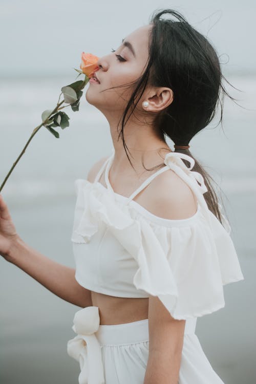 Free Photo Of Woman Sniffing Flower Stock Photo