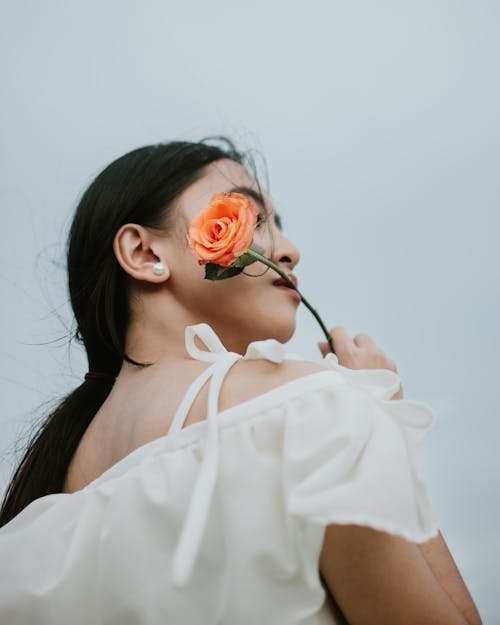 Photo Of Woman Holding A Flower