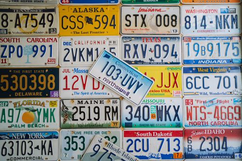 Free A colorful collage of vintage US license plates from various states on display. Stock Photo