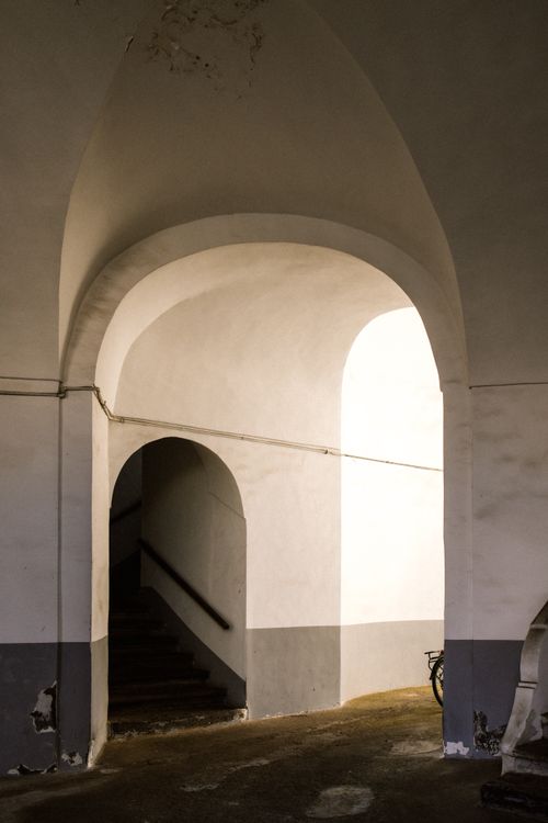 Free Elegant arched corridor with soft lighting in Procida, Italy, showcasing classic architecture. Stock Photo
