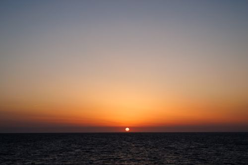 Free Beautiful sunset over the Mediterranean Sea at Procida, Italy, with vivid colors and serene horizon. Stock Photo