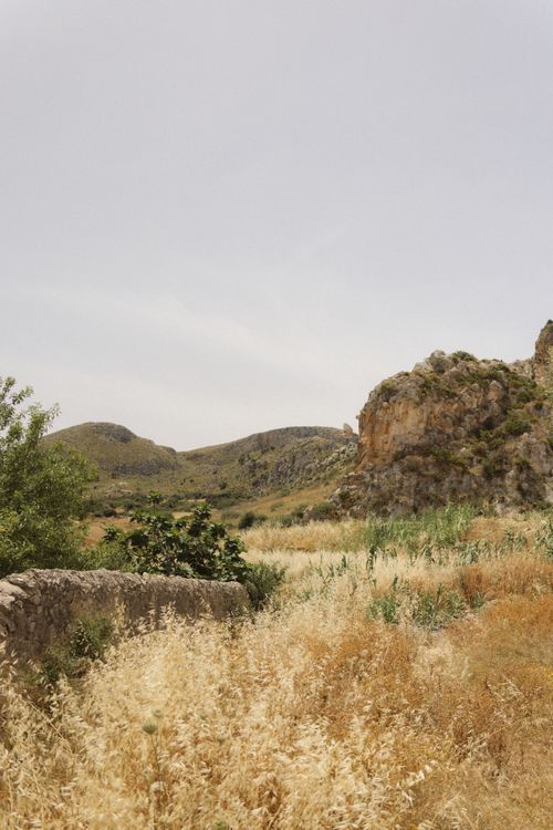 Free Explore the tranquil beauty of a countryside landscape with dry grass and rolling hills. Stock Photo