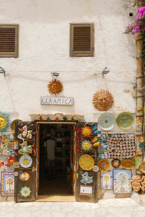 Free Colorful ceramics shop with artistic door in summer sunlight on historic street. Stock Photo