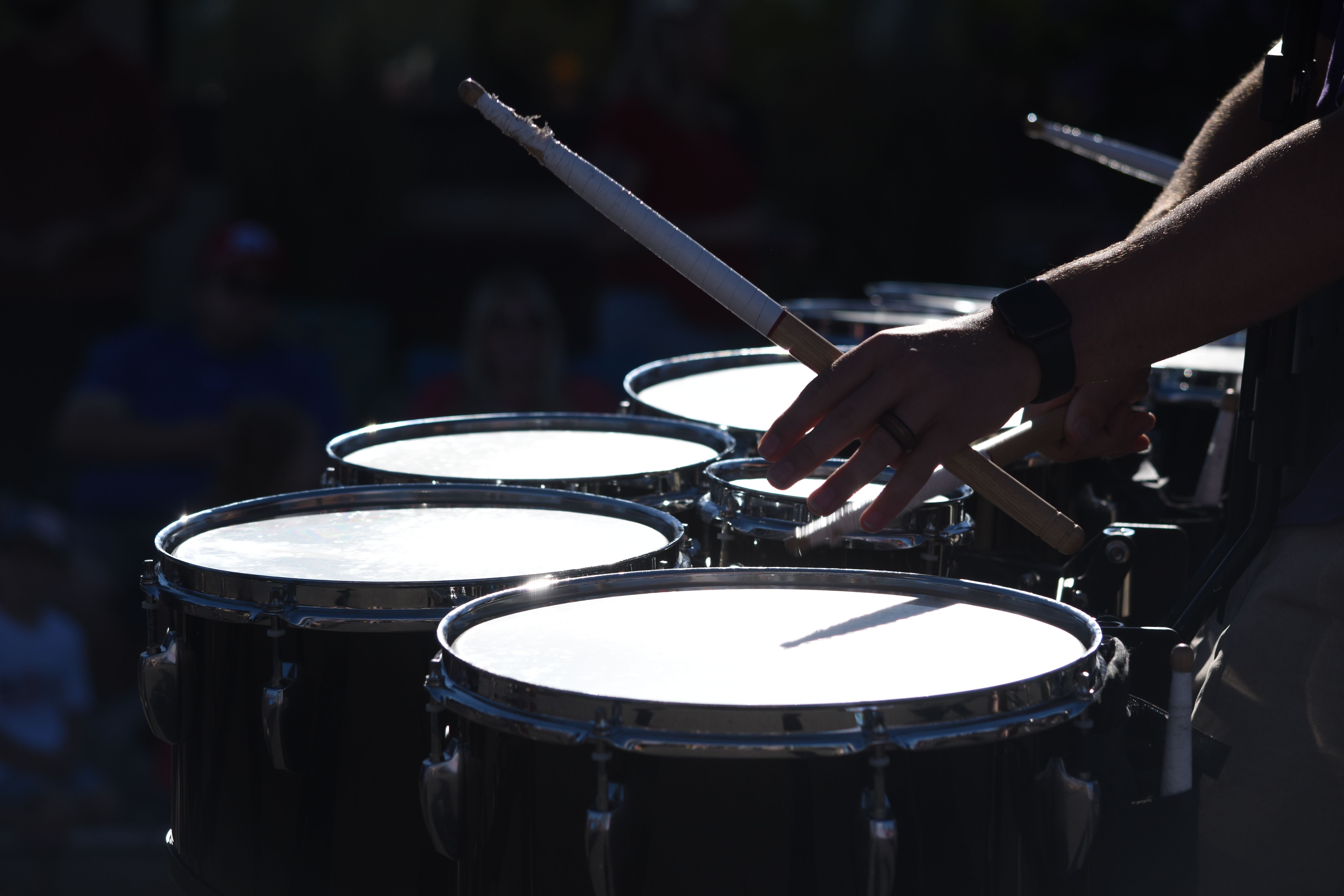 Close-up of Ewe drums being played during a church service, hands blurred in motion