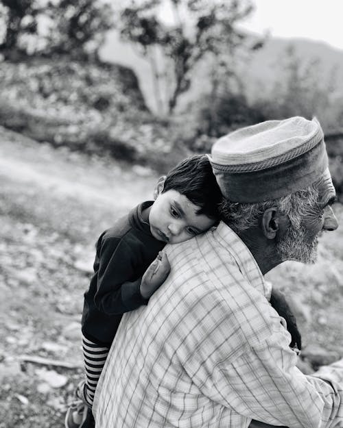 Boy Leaning Beside An Old Man
