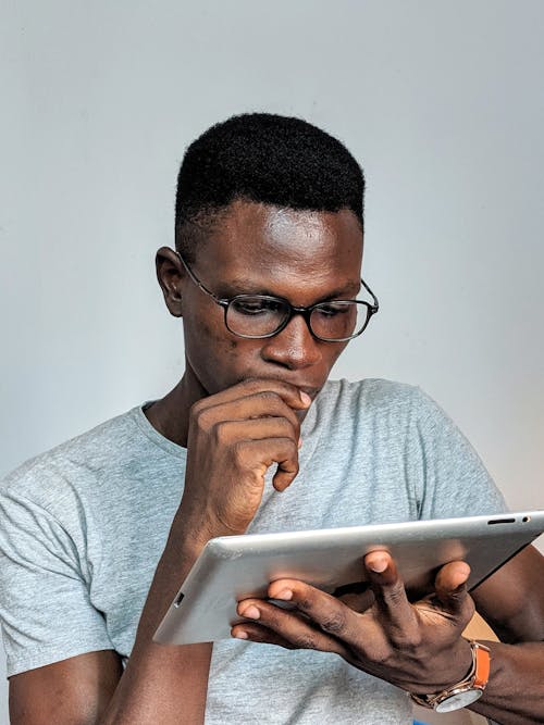 Free Man Looking at Ipad Pro Stock Photo