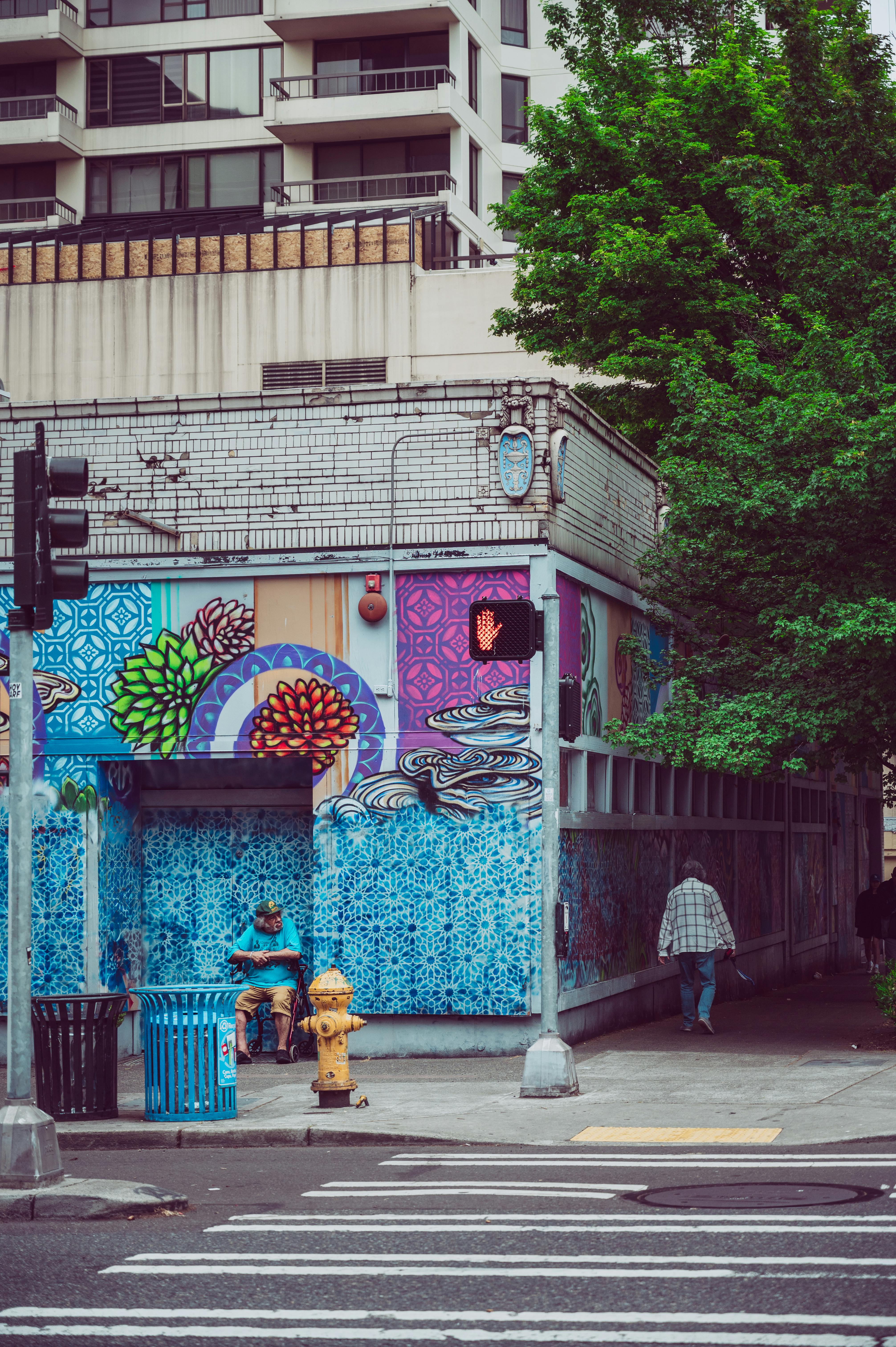 a street corner with a building with graffiti on it