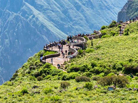 Tourists enjoy a breathtaking view from a scenic overlook at Colca Canyon in Arequipa, Peru.