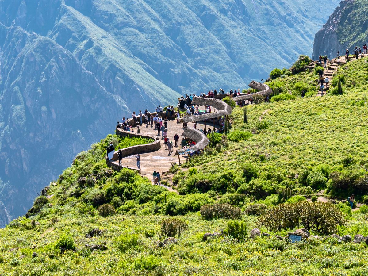 Tourists enjoy a breathtaking view from a scenic overlook at Colca Canyon in Arequipa, Peru.