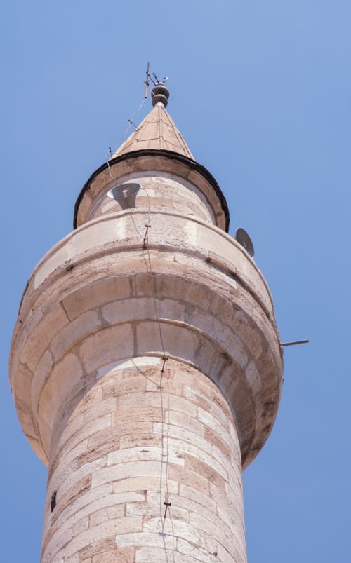 Free A detailed low-angle view of a historic minaret in İzmir with clear blue skies. Stock Photo