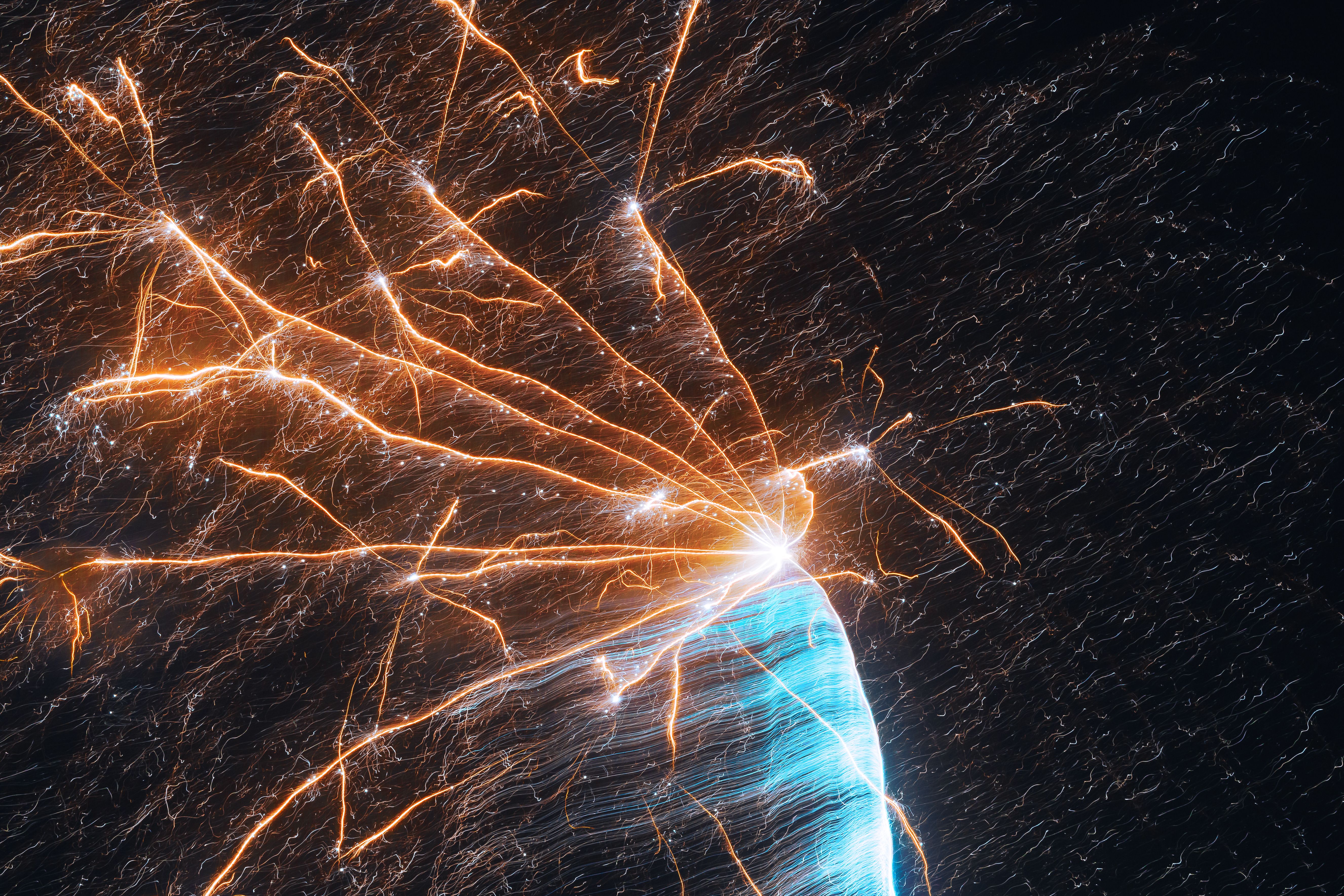 A close up of a firework with orange and blue sparks · Free Stock Photo