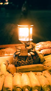 A cozy night bazaar scene featuring fresh corn illuminated by warm lantern light, creating a vibrant ambiance.