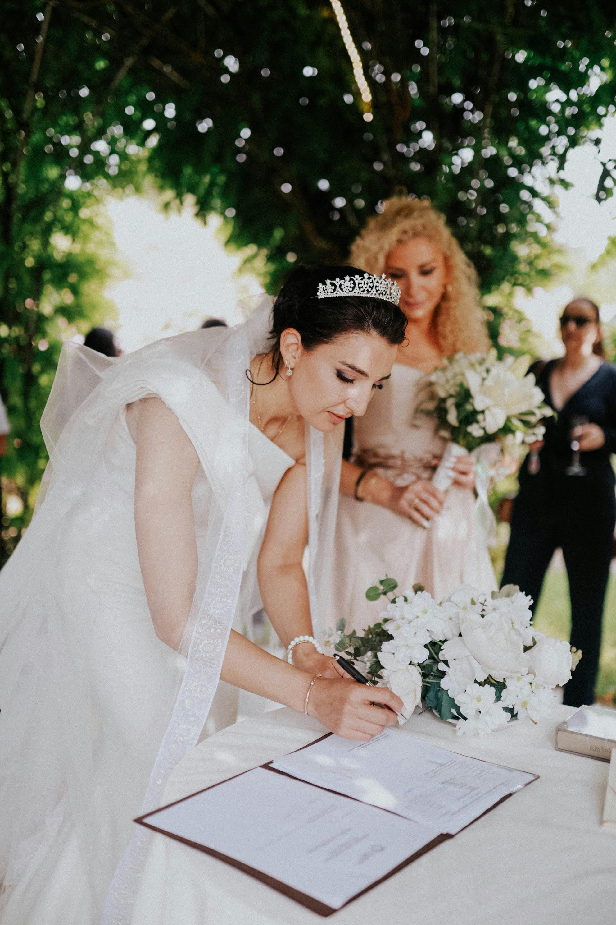 bride signing a book on celebration