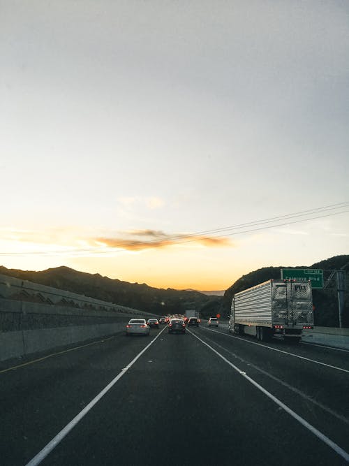 Vehicles on Road During Golden Hour
