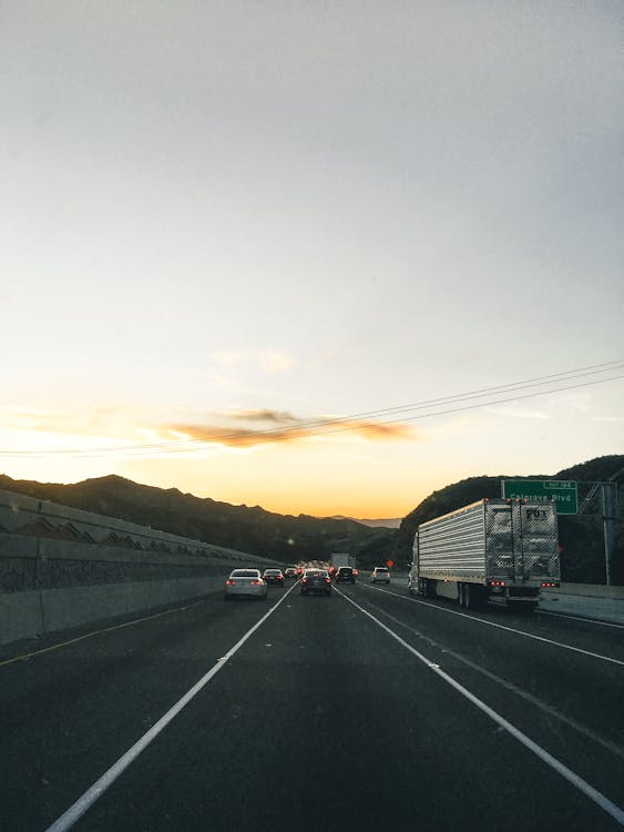 Free Vehicles on Road During Golden Hour Stock Photo