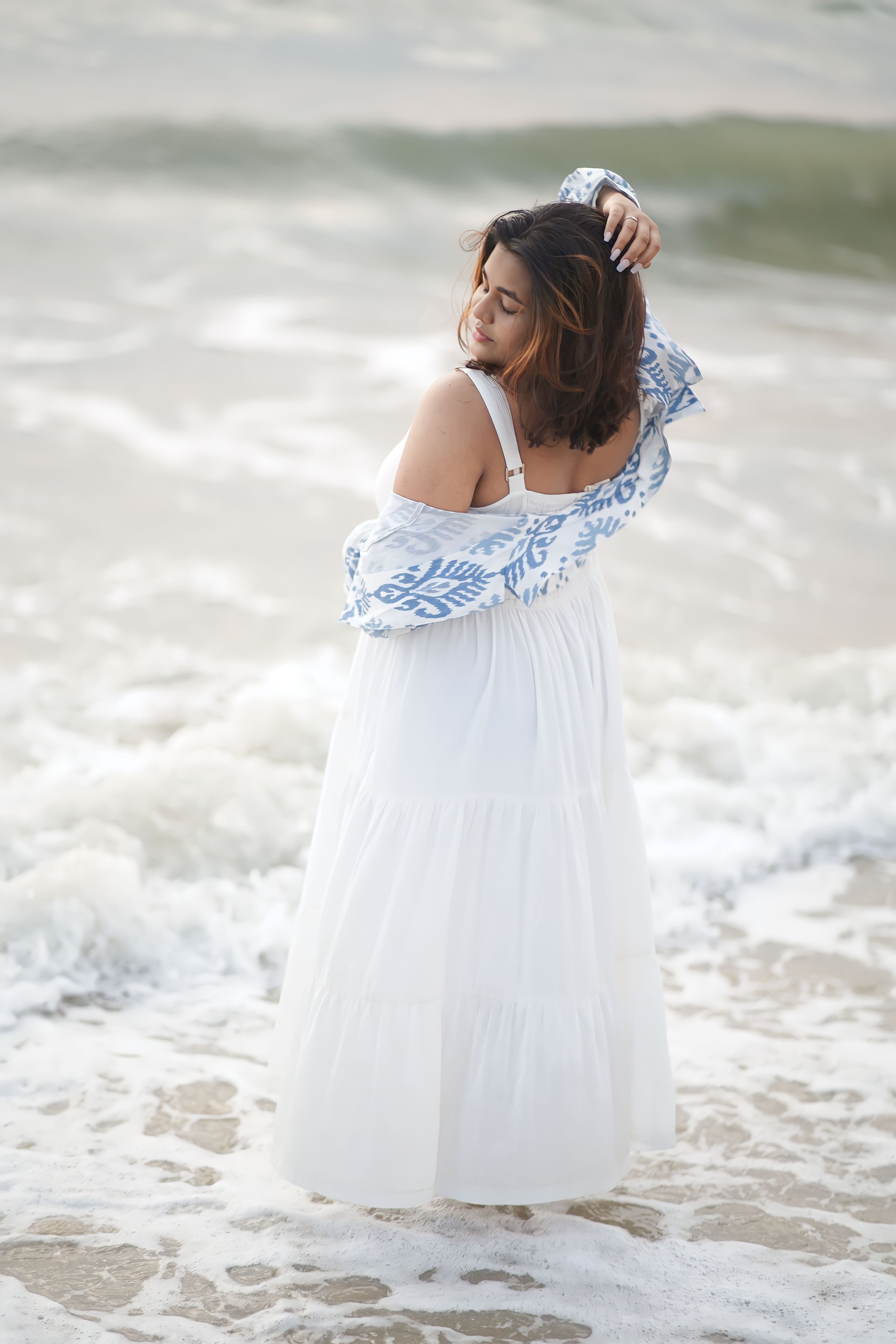 A woman in a white dress standing in the ocean · Free Stock Photo