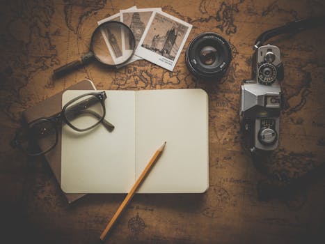 Silver Dslr Camera Beside Book