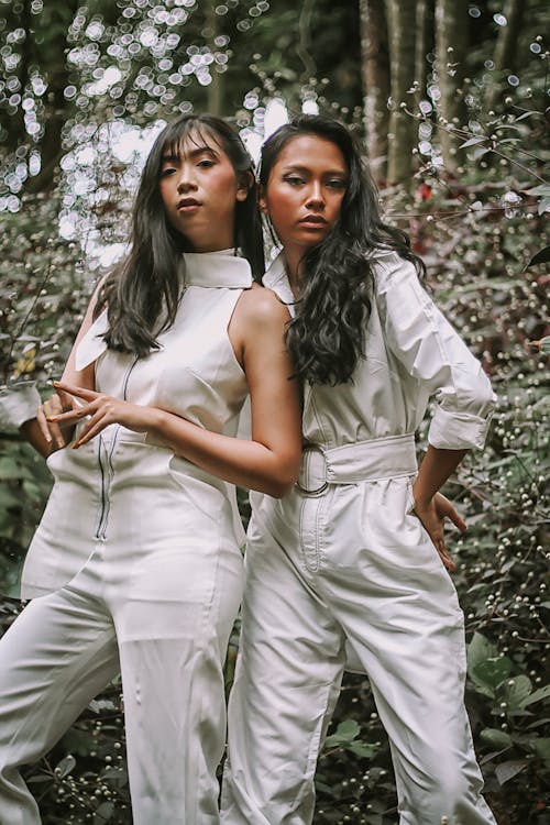 Photo of Two Women Wearing White Jumpsuit