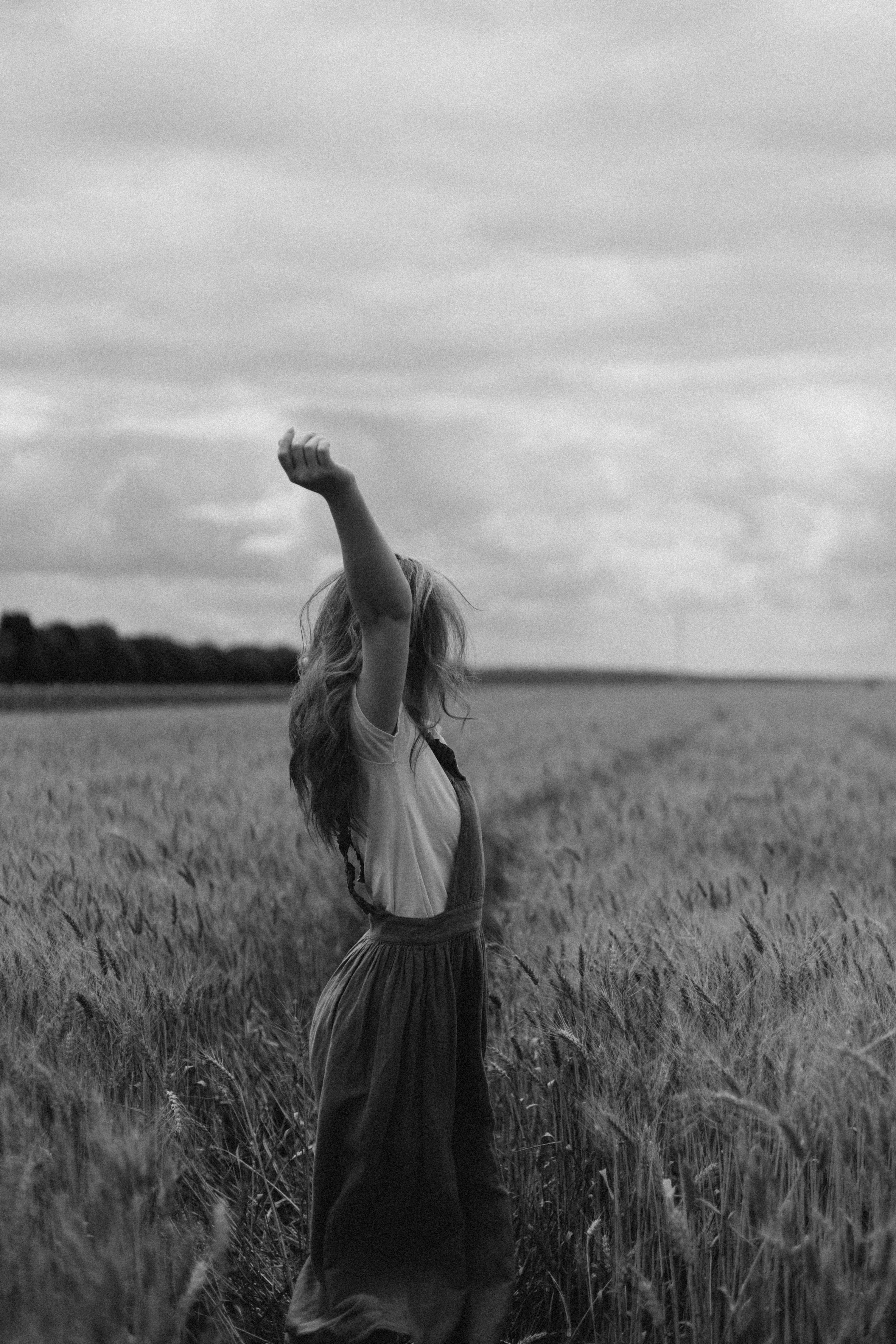 A woman in a field with her arms up