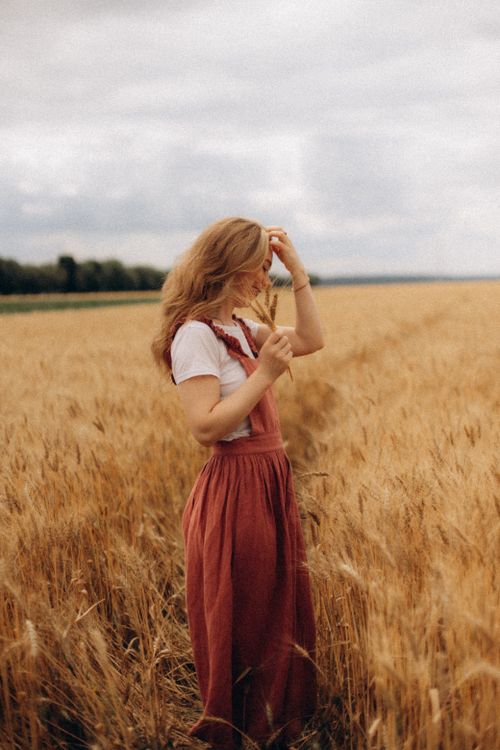A Woman Standing on a Wheat Field · Free Stock Photo